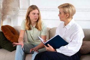 young-girl-talking-therapist-medium-shot